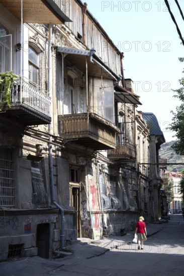 Tbilisi, Georgia. July 29th 2025. A women walks in the quiet streets of Tbilisi old town, with its narrow streets and traditional architecture. Georgia