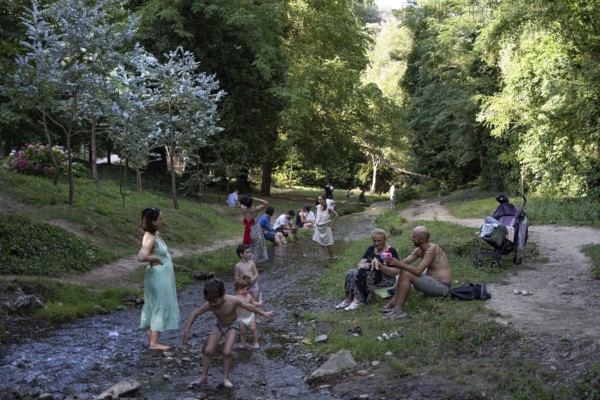 Tbilisi, Georgia. July 13th 2025. Georgian families enjoy the shade and cold water stream of the National Botanical Garden of Georgia, a valuable green space in the Tsavkisis-Tskali Gorge, Tbilisi