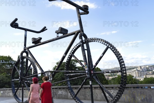 Tbilisi, Georgia. July 11th 2025. The Big Bike Monument, the famous Tbilisi landmark is a place where tourists and locals come to take pictures and admire the city view