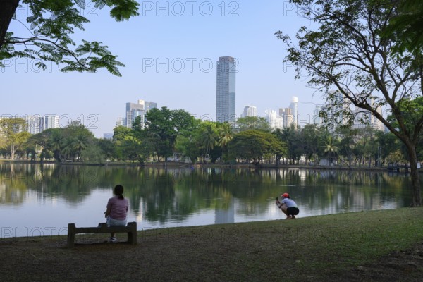 Bangkok, Thailand. March 4th 2025. People enjoy the calm and peaceful green environment beside the lake in Lumphini Park, Bangkok