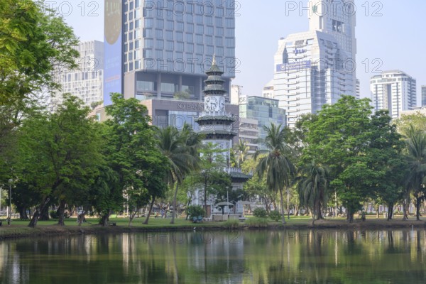 Bangkok, Thailand. March 4th 2025. The Chinese Clock Tower seen with the modern high rise buildings of Bangkok in Lumphini Park