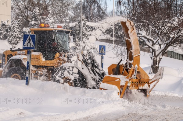 Snow blower clears snow on street in Ystad, Skåne County, Sweden, Scandinavia