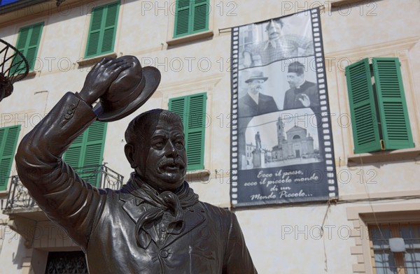 Italy, village of Brescello, the town hall, known from Don Camillo and Peppone, with a bronze figure of Peppone, Mayor Giuseppe Bottazzi portrayed by actor Gino Cervi