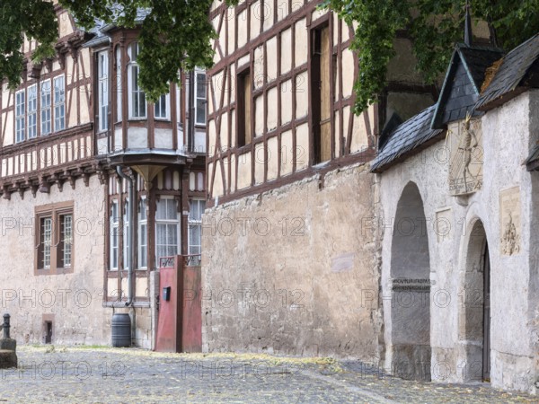 The slate courtyard, representative half-timbered building, the death of Gorsleben in front, sundial on the cemetery wall in the small village of Gorsleben, Thuringia, Germany