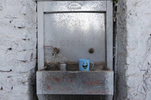 Aswan, Egypt. December 9th 2022 Cean water drinking fountain with plastic smiley face mug, along the Nile River in Upper Egypt near the city of Aswan, Egypt