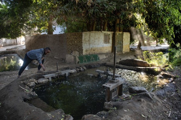 Aswan, Egypt. 9th December 2020 A Nubian man controls a sluice gate that channels water from the River Nile to agricultural land on Elephantine Island, Aswan, Egypt
