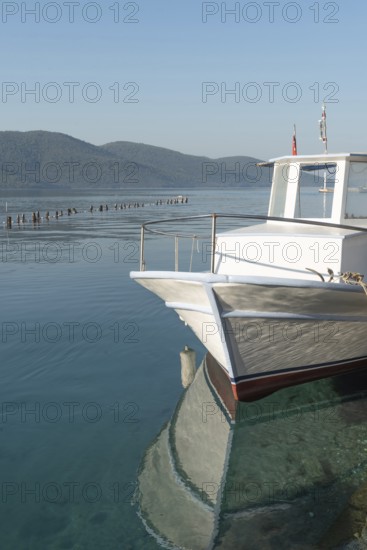 Stunning view of a boat moored in the beautiful harbour of Turkish Riviera seaside town of Akyaka on the south west coast of Turkey