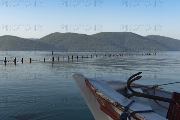 A boat moored in the beautiful harbour at the entrance to the Azmak River, at the Turkish Riviera seaside town of Akyaka on the south west coast of Turkey