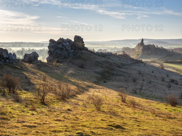 Rock formations in the Teufelsmauer nature reserve in morning light and morning fog, near Weddersleben, Harz, Saxony-Anhalt, Germany