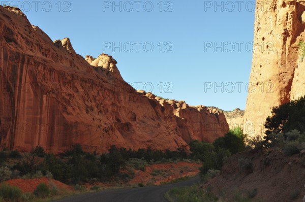 The road crosses a gorge with impressive rock formations and changing light effects, Grand Staircase Escalante National Monument, Utah, USA