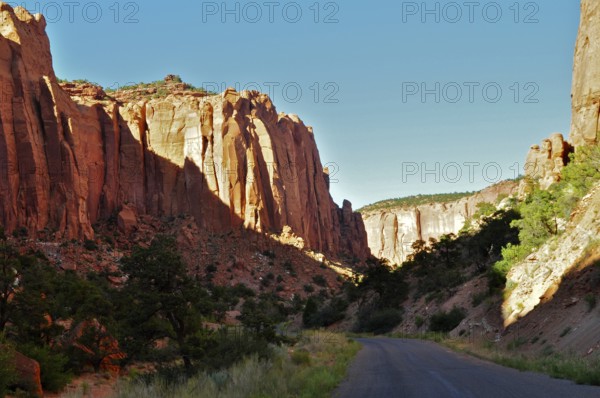 Tall rocks frame a road leading through a dramatic canyon landscape, Grand Staircase Escalante National Monument, Utah, USA