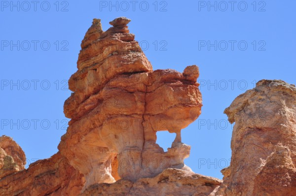 Close-up of sculptural, natural red rock formation under blue sky, Bryce Canyon National Park, Utah, USA