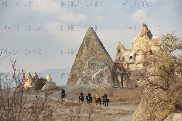 Cappadocia, Turkey. November 8th 2017 Canan a horse trekking guide from the Dalton Brothers Ranch leads a group of tourists through the volcanic landscape of Cappadocia in central Anatolia, Turkey