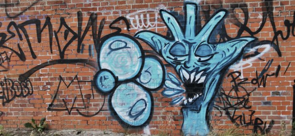 Creative graffiti on a brick wall in shades of blue, Olsztyn, Masuria, Poland