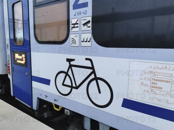 Side view of a train with bicycle symbol and blue paint, Polish bicycle compartment, cycling in Poland