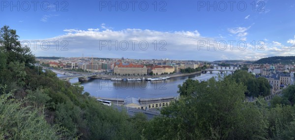 Urban landscape with river and several bridges on a slightly cloudy day