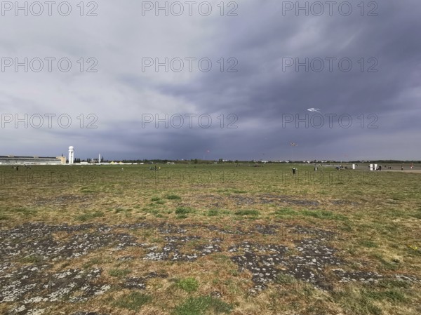 Cloudy sky over a wide field with flying dragons, Tempelhofer Feld in autumn, Berlin