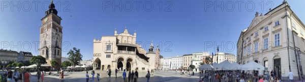 Panoramic view of a historic square with surrounding buildings and visitors, Krakow, Poland