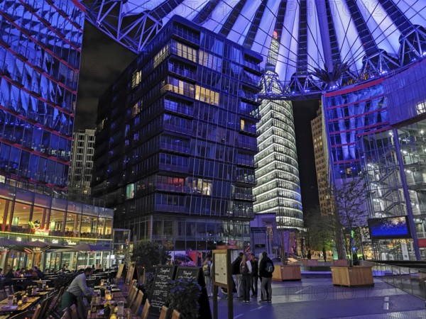 Center am Potsdamer Platz in Berlin at night with blue lighting and lively atmosphere, Berlin