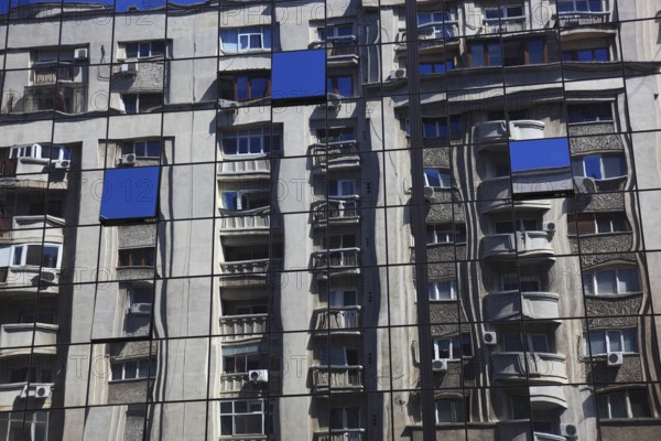 Romania, capital city Bucharest, Bucuresti, reflection in a glass façade