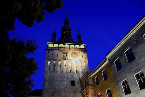 Romania, hour tower at the blue hour in the historic old town of Sighisoara, German Sighisoara, town in Mures district in Transylvania, UNESCO World Heritage Site