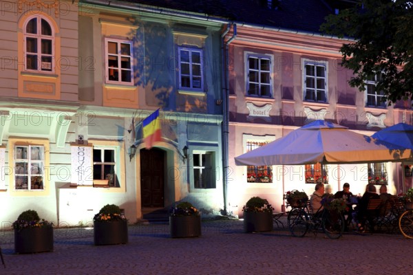 Romania, restaurant in the Upper Town, at blue hour in the historic old town of Sighisoara, German Sighisoara, town in Mures district in Transylvania, UNESCO World Heritage Site