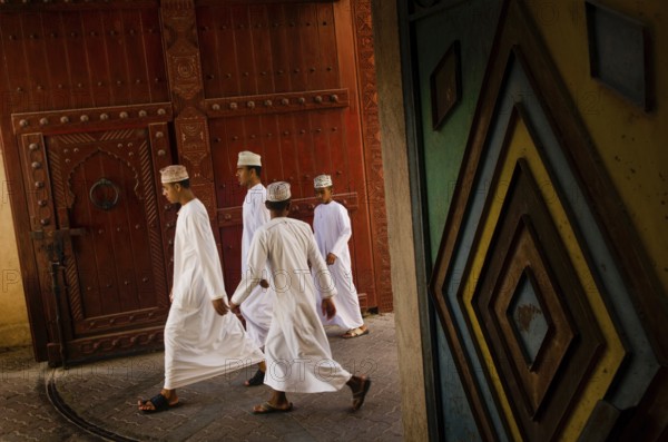 Nizwa, Oman. May 30th 2014 A group of young Omani men in traditional clothes, Nizwa souk, Oman