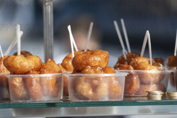 Lokma, traditional deep fried Turkish dessert, street food for sale all over Turkey but the sweet made of syrup and dough is famous in Izmir