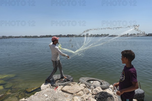 Rosetta, Egypt. June 27th 2024 A local Egyptian fishermen castes his weighted net into the River Nile at Rosetta in the Nile Delta in Northern Egypt