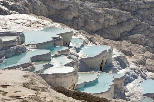 Pamukkale Travertine Terraces, amazing aqua blue pools of thermal mineral rich spring water set against a geological rock formation, world heritage site and popular tourism destination in south west Turkey