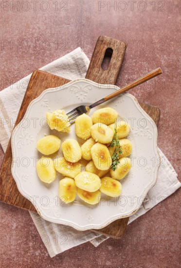Stuffed gnocchi with cheese, Italian dumplings, garnished with parmesan cheese, no people