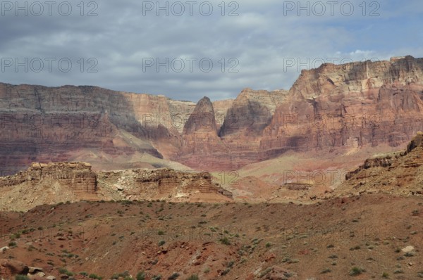 Dramatic rock formations in a vast desert landscape under a cloudy sky, Grand Canyon National Park, Arizona, USA