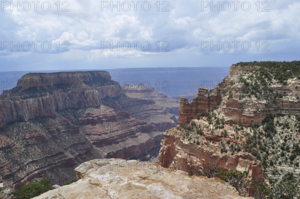 Deeply cut rock canyons with dramatic cliffs under a cloudy sky, Grand Canyon National Park, Arizona, USA