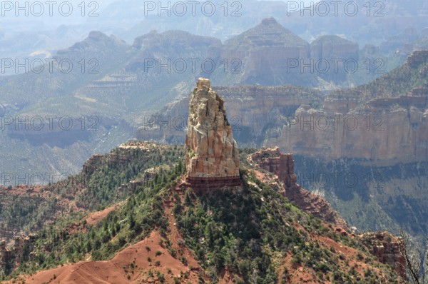 A distinctive rock formation rises in the midst of a rough and dry canyon landscape with wide views, Grand Canyon National Park, Arizona, USA
