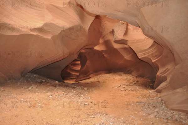 Soil of sand and rocks in an open natural cave with soft curves, Antelope Canyon, Navajo Nation Reservation, Lake Powell Tribal Park, Arizona, USA