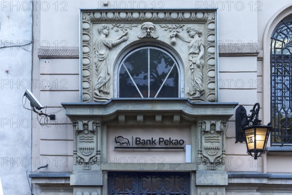Art Nouveau relief over an entrance to a ban, around 1900, Krakow, Poland