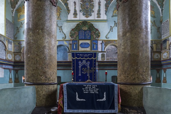 Columns of the central bima, a parish in the back, curtain in front of the Torah shrine, synagogue in Lancut formerly Landshut, Poland