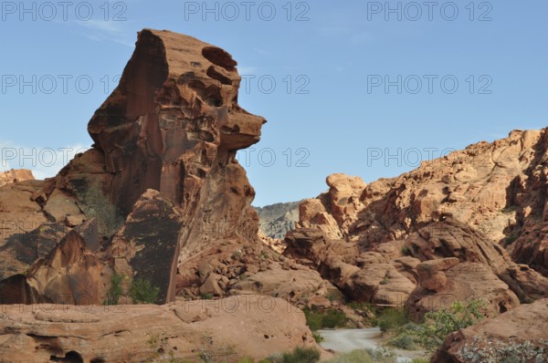 Large red sandstone rock formation in the desert with clear sky in the background, Valley of Fire State Park, Nevada, USA