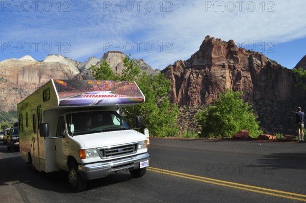 Motorhome on a road in front of impressive mountain panorama under blue sky, Zion National Park, Utah, USA
