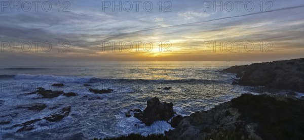 A breathtaking sunset over the sea with dramatic waves and rocks, hiking the Fisherman's Trail, hiking the Fisherman's Trail, Southwest Alentejo nature park Park and Vicentina Coast, Portugal