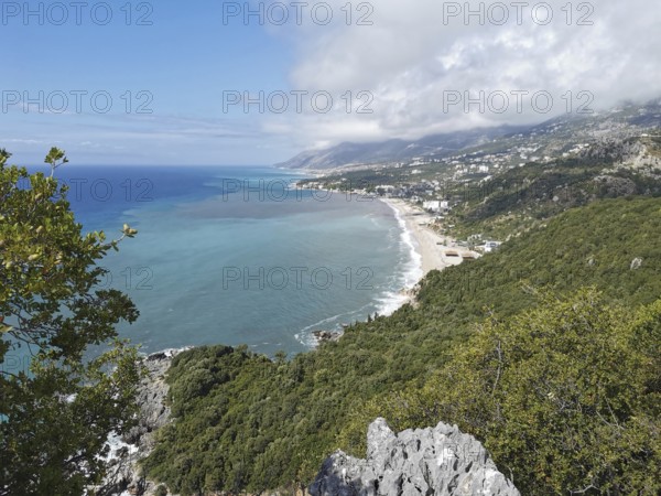 Extensive view of a coastal town surrounded by forests and mountains, Dhermi, Albanian Riviera, Albania