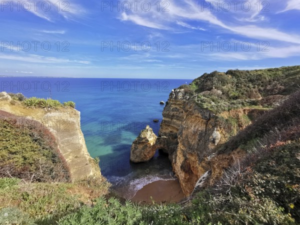 Picturesque coastal landscape with high cliffs and turquoise blue sea, Lagos, Algarve, Portugal