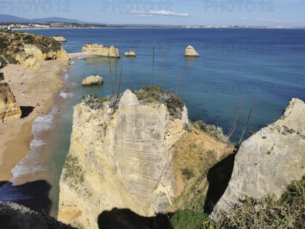 Breathtaking coastal view with sandy beaches and imposing rock faces, Lagos, Algarve, Portugal