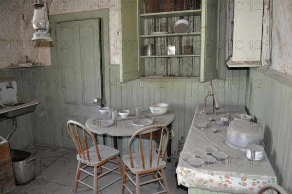Dusty kitchen, vintage kitchen with old dishes and furniture in an abandoned setting, Bodie Ghost Town, California, USA