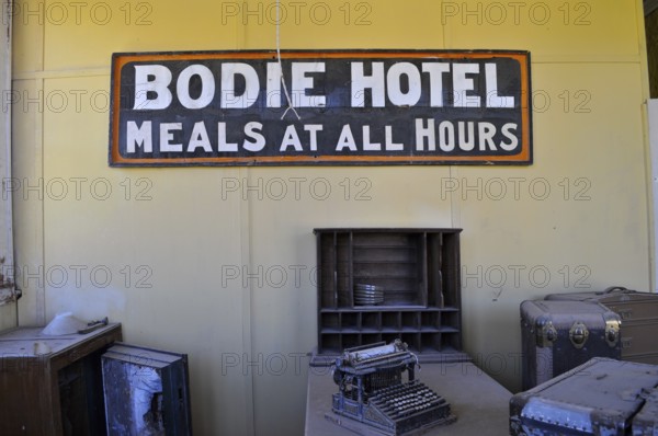Sign of an old hotel with antique objects such as a typewriter, Bodie Hotel, Bodie Ghost Town, California, USA