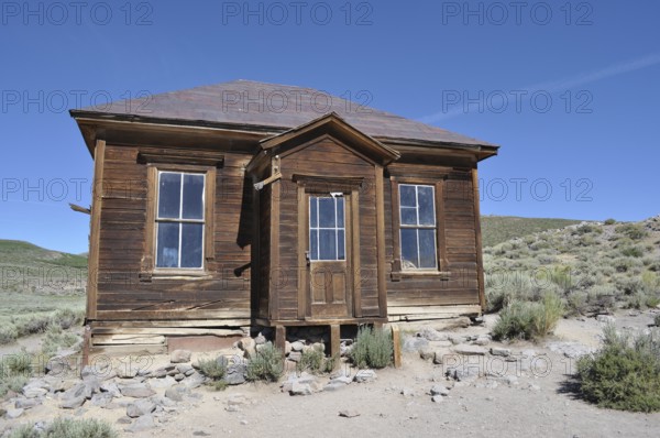 Ruined wooden house in a ghost town surrounded by arid countryside, Bodie Ghost Town, California, USA