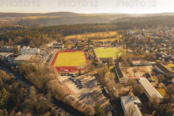 Comprehensive view of the city and surrounding area with sports fields and forest from the air, Wimberg, Calw, Germany