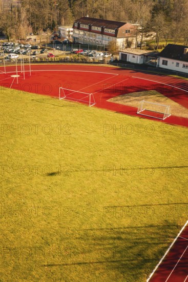Close-up of a sports field with running track and shade on the grass, Wimberg, Calw, Germany