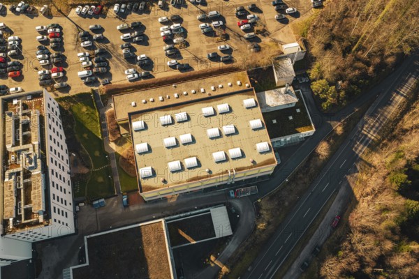 Aerial view of a flat roof and adjacent parking lot with lots of cars, Wimberg, Calw, Germany