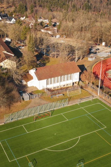 Aerial view of a soccer field with adjacent grandstand and surrounding trees, Wimberg, Calw, Germany